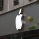 Close-up of Apple Store exterior featuring the illuminated logo prominently displayed.