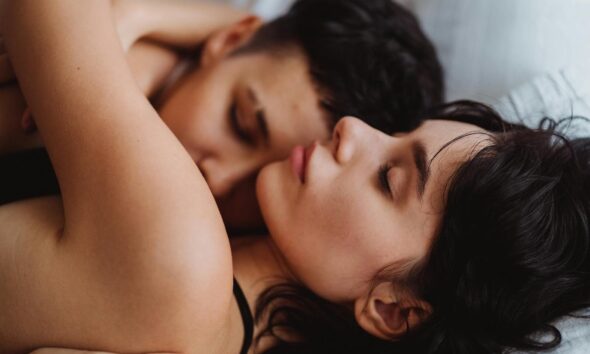 A tender embrace between a loving couple, showcasing intimacy and affection indoors.