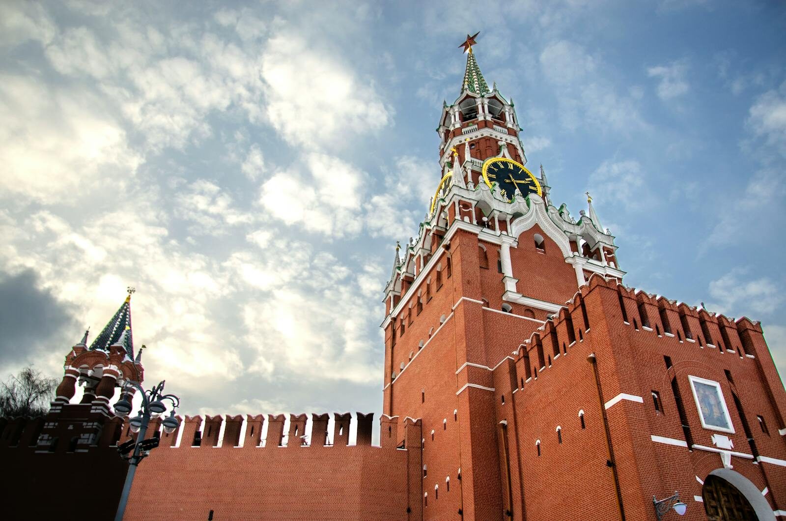 View of the Spasskaya Tower of the Moscow Kremlin against a cloudy sky. Architectural landmark.