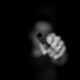 grayscale photography ofperson holding gun