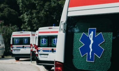 Three ambulances parked outdoors, ready for emergency healthcare situations.