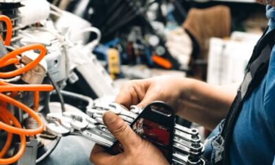 Experienced male technician working on complex machinery in workshop.
