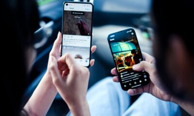 A couple engaging with social media on smartphones indoors, illustrating modern digital connectivity.