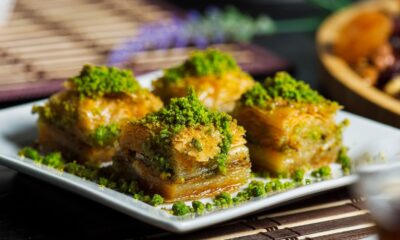 Enjoy a mouthwatering close-up of authentic baklava topped with vibrant pistachios. Perfect for food lovers.