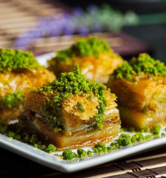 Enjoy a mouthwatering close-up of authentic baklava topped with vibrant pistachios. Perfect for food lovers.