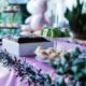 Vibrant party table setup with colorful cakes, pastries, and decorations in a festive setting.