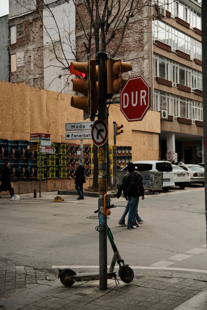 City intersection in Turkey with stop sign, pedestrians, and buildings