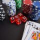 A vibrant display of casino chips, dice, and playing cards set on a table, embodying chance and excitement.
