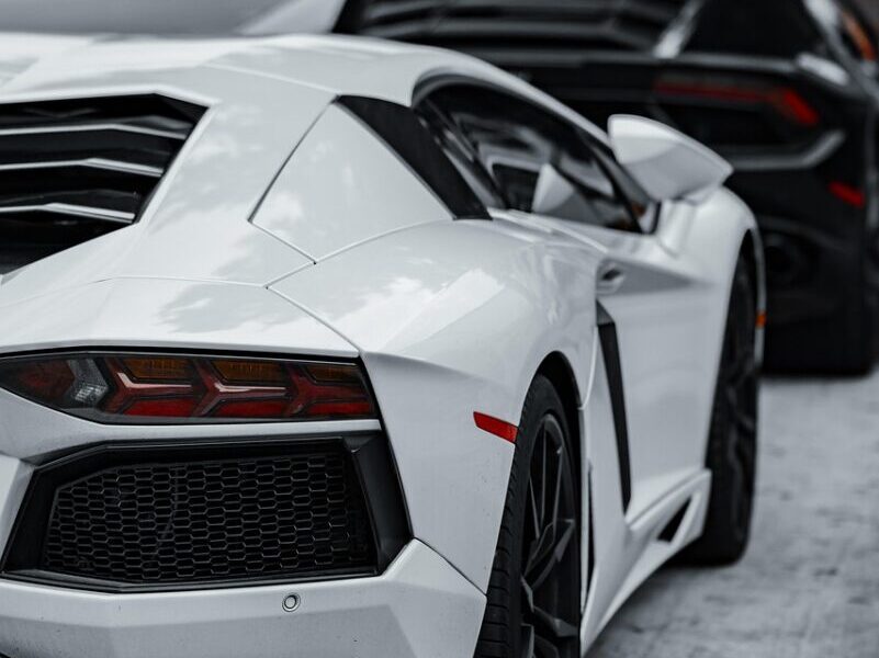 cars, super cars, luxury cars, lamborghini, corvette, black car, white car, sports cars, exotic cars, daytime, parked cars, car row, black lamborghini, white lamborghini, black corvette, high-end vehicles, automobile, car collection, outdoor