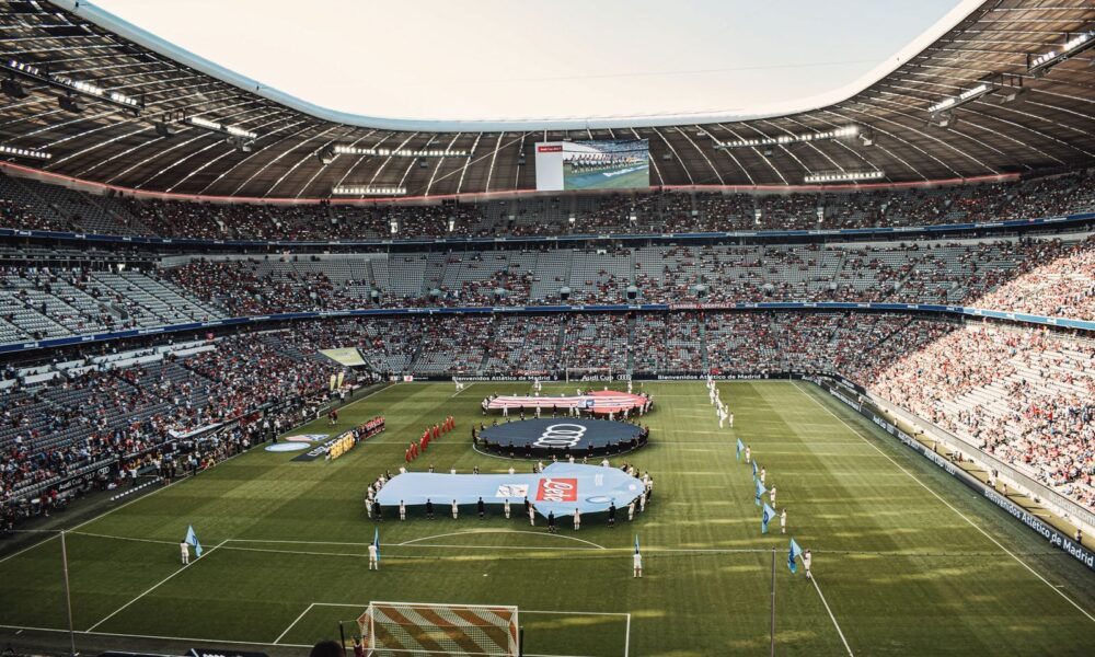 Captivating view of a soccer match at Munich's iconic Allianz Arena, filled with excited fans.