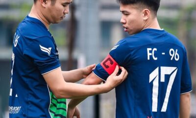 Two soccer players getting ready for a match on a field in Hanoi, Vietnam.