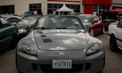Honda dealership showcasing a sleek parked car on a cloudy day.
