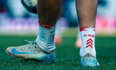 Close-up shot of a soccer player on the field with a focus on the feet and ball.