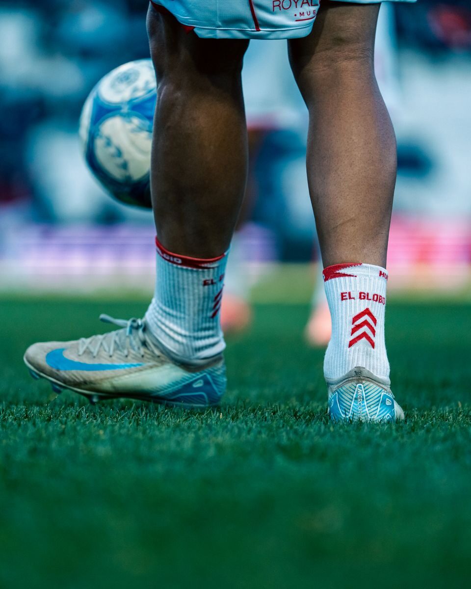 Close-up shot of a soccer player on the field with a focus on the feet and ball.