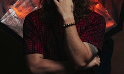 A pensive man poses with studio lights creating a striking, dramatic effect.