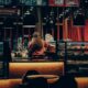 Warmly lit café with a barista working behind the counter, creating an inviting atmosphere.