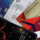 Image showing credit cards and a financial market graph on a smartphone.