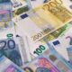 Close-up of various Euro banknotes scattered on a surface, highlighting European currency.
