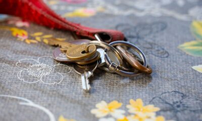 A set of keys lying on a floral-patterned fabric background. Ideal for security themes.
