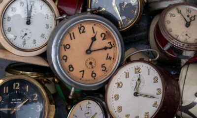 Close-up view of a collection of vintage alarm clocks with various designs, showcasing time's passage.