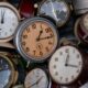 Close-up view of a collection of vintage alarm clocks with various designs, showcasing time's passage.