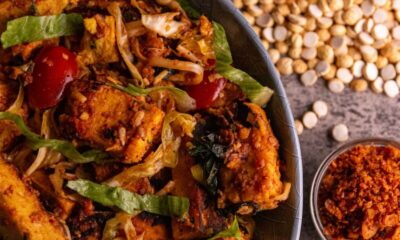 A delicious tofu stir-fry with cherry tomatoes, lettuce, and spices served in a rustic style.