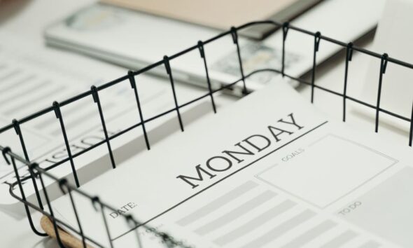 Top view of a Monday planner in an office setting, ideal for organizing schedules.
