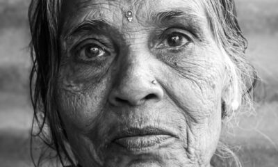 Intimate black and white portrait of an elderly South Asian woman in Varanasi, showcasing wisdom and experience.