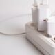 A minimalist charging station with multiple white USB plugs neatly arranged.