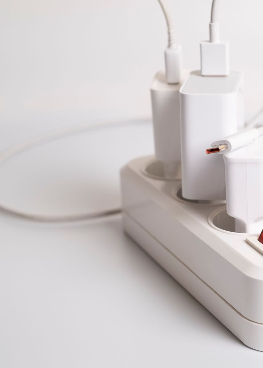 A minimalist charging station with multiple white USB plugs neatly arranged.