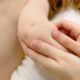 Close-up image of a baby receiving a gentle arm massage, highlighting the soothing touch.