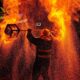 Stunning fire performer with flames and sparks in a nighttime show.