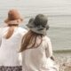 beach, hats, women, pair, couple, fashion, style, stylish, backs, young women, shore, seashore, friendship, girl friends, ocean, nature, outdoors, people, sand, sea, water, friends
