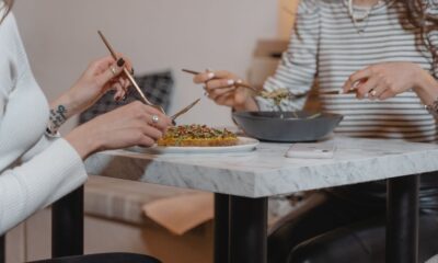 Two women sharing a healthy meal indoors, emphasizing friendship and togetherness.