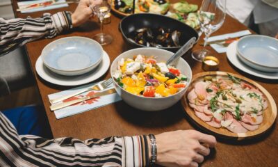 A vibrant dining table setting featuring a colorful salad, seafood, and more.