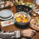 A vibrant dining table setting featuring a colorful salad, seafood, and more.