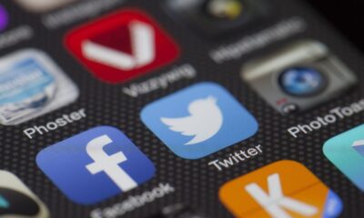 A detailed close-up of social media icons on a smartphone screen, including Facebook and Twitter.