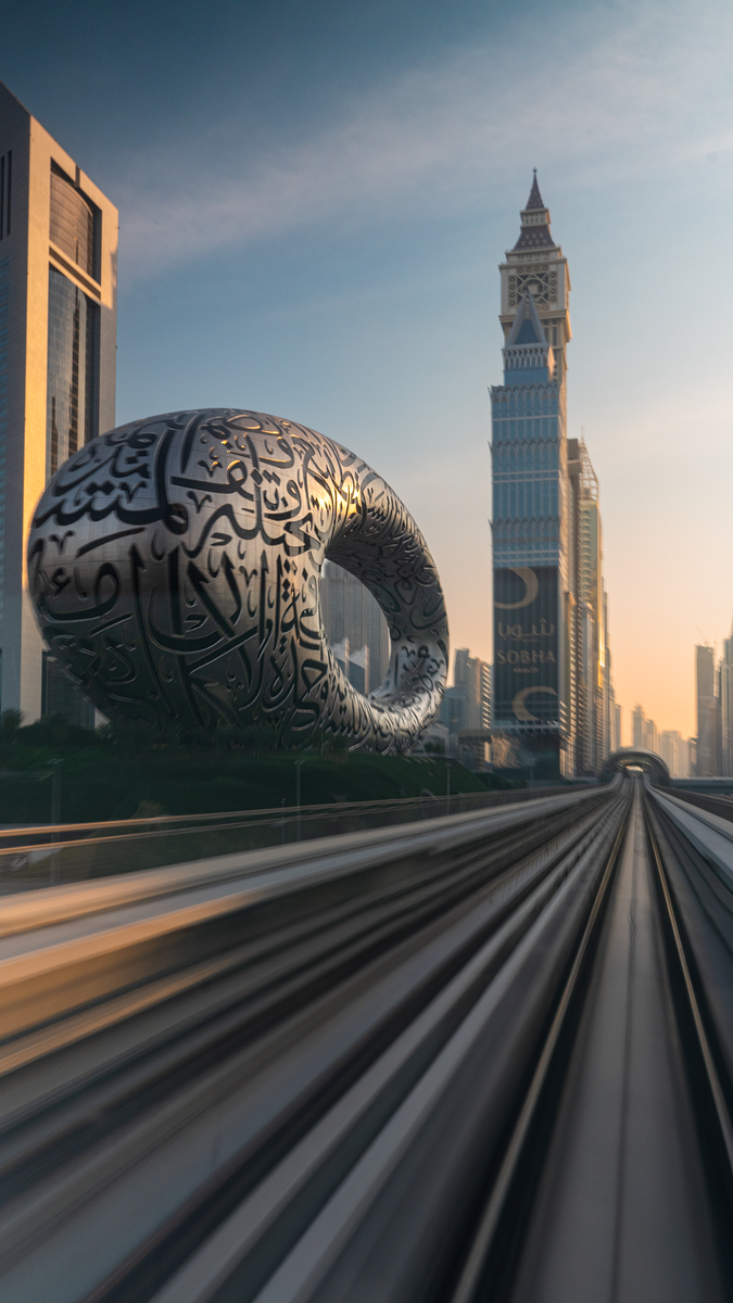 The Museum of the Future and Dubai's skyline captured beautifully at sunset in an urban setting.