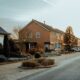 Brick houses lining a quiet street in the Netherlands, Missouri, USA, under a clear sky.