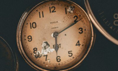 Captivating close-up of a vintage analog clock showcasing historical charm and intricate details.