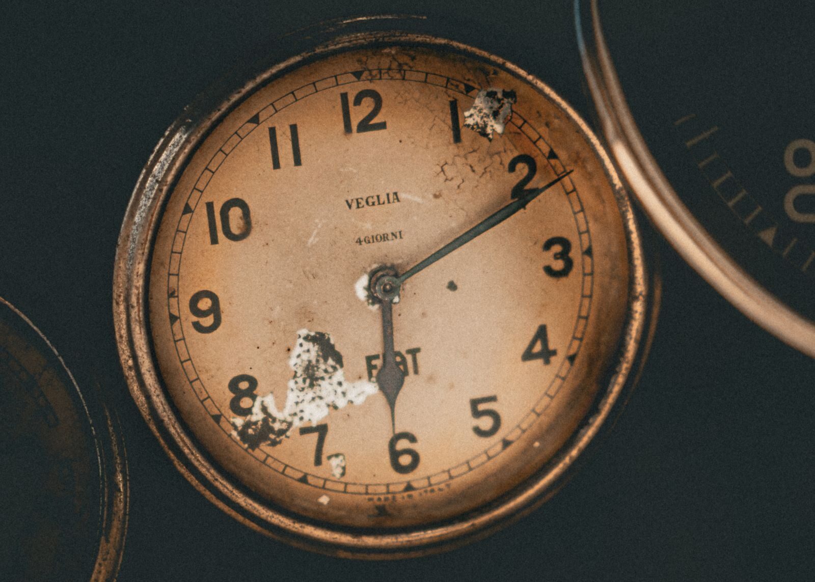 Captivating close-up of a vintage analog clock showcasing historical charm and intricate details.