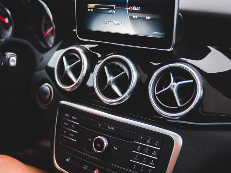 Small black touchpad and loud speakers of modern multimedia player in cabin of automobile