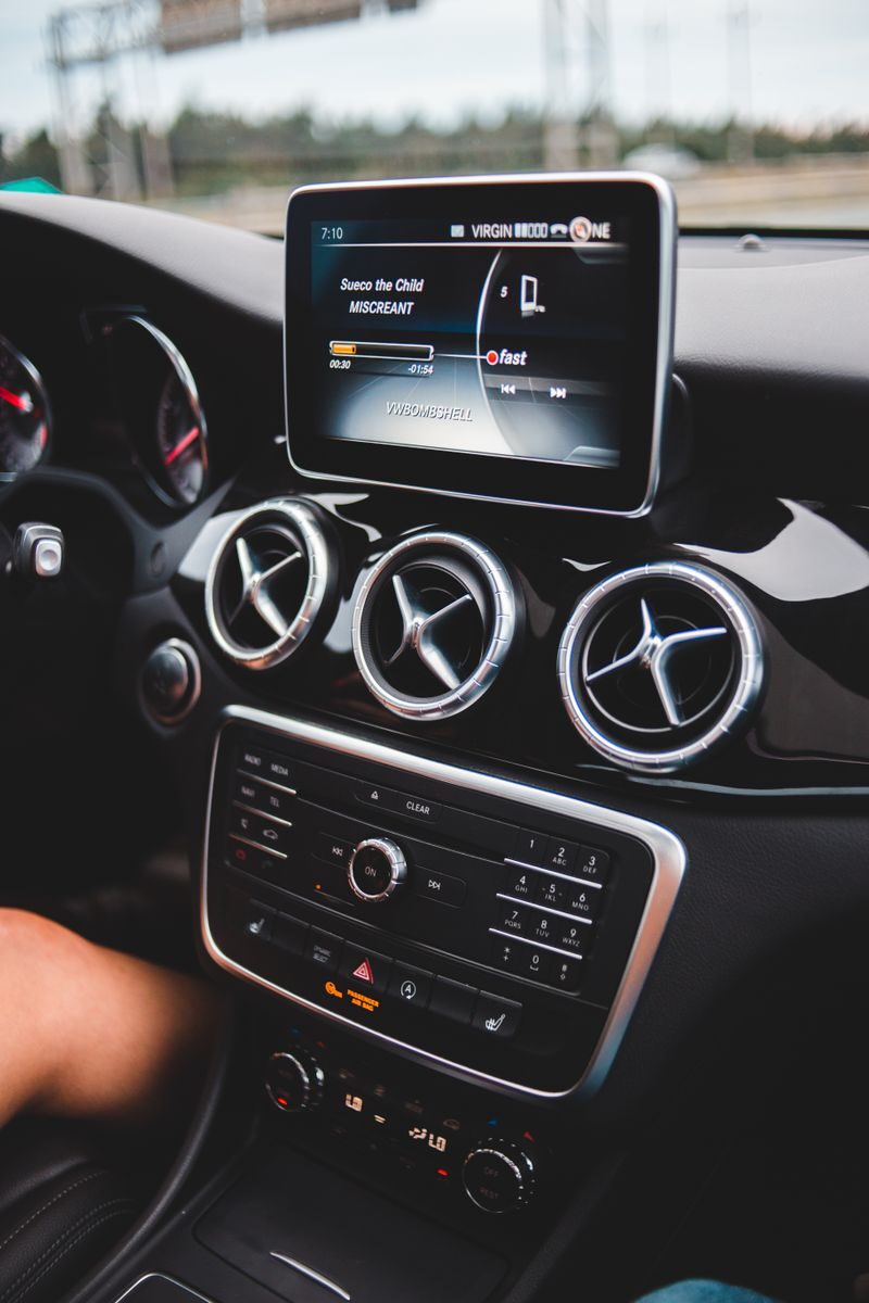 Small black touchpad and loud speakers of modern multimedia player in cabin of automobile