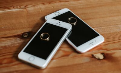 Engagement rings placed on smartphones symbolizing modern connectivity and love.