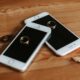 Engagement rings placed on smartphones symbolizing modern connectivity and love.