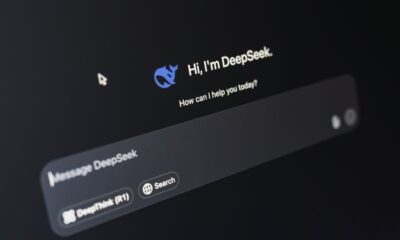 Close-up of a laptop displaying an AI interface with a chatbot prompt in dark mode.