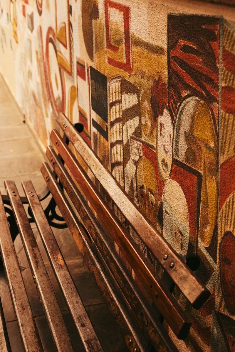 Vibrant street art mural with a rustic bench in Belo Horizonte, Brazil.
