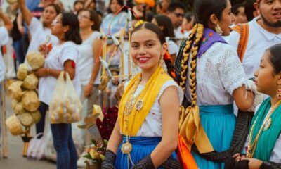 Colorful celebration in Oaxaca, showcasing traditional clothing and joyful participants.