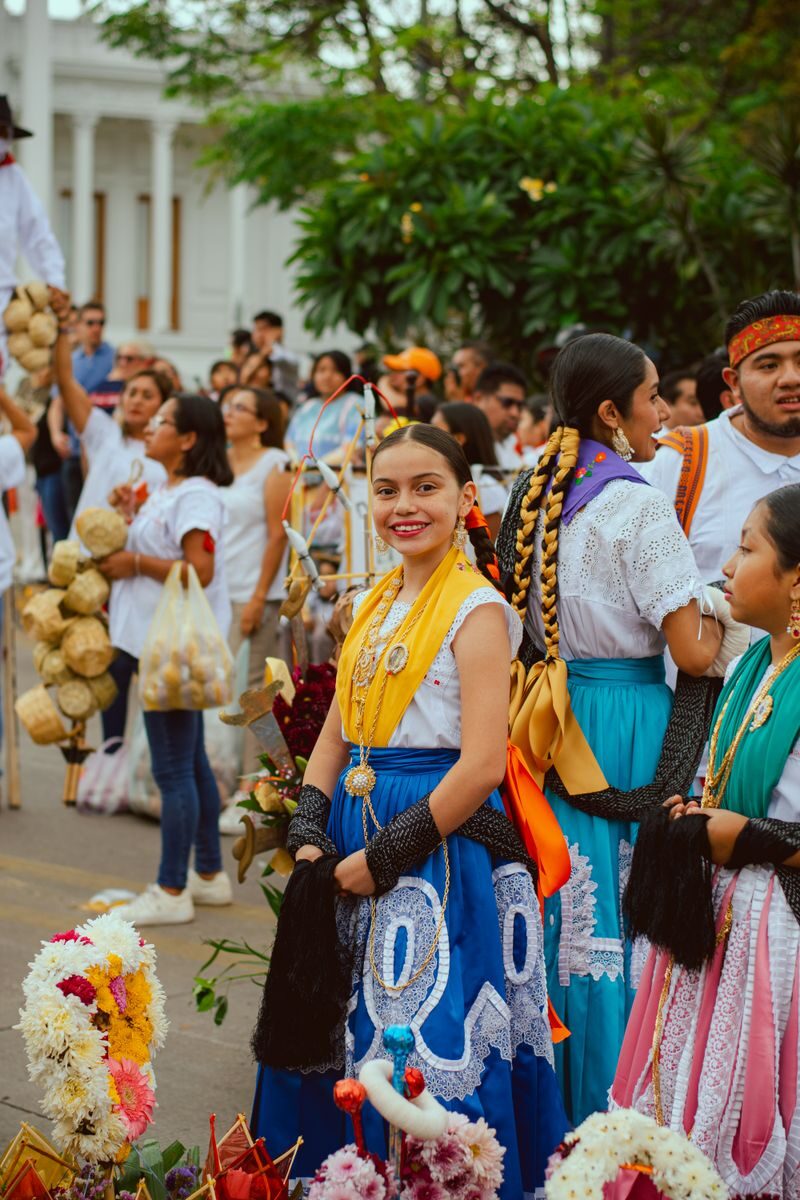 Colorful celebration in Oaxaca, showcasing traditional clothing and joyful participants.