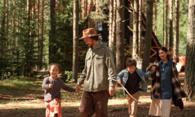 A family enjoys a day of hiking and exploring in a dense forest, promoting outdoor fun and bonding.